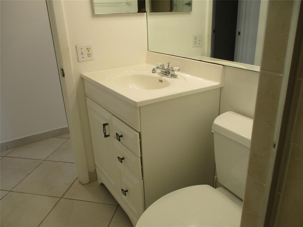 9233 Southwest 8th Street, Unit 311 Boca Raton, FL 33428 - Photo 16 of 19 a bathroom with a sink a toilet and shower