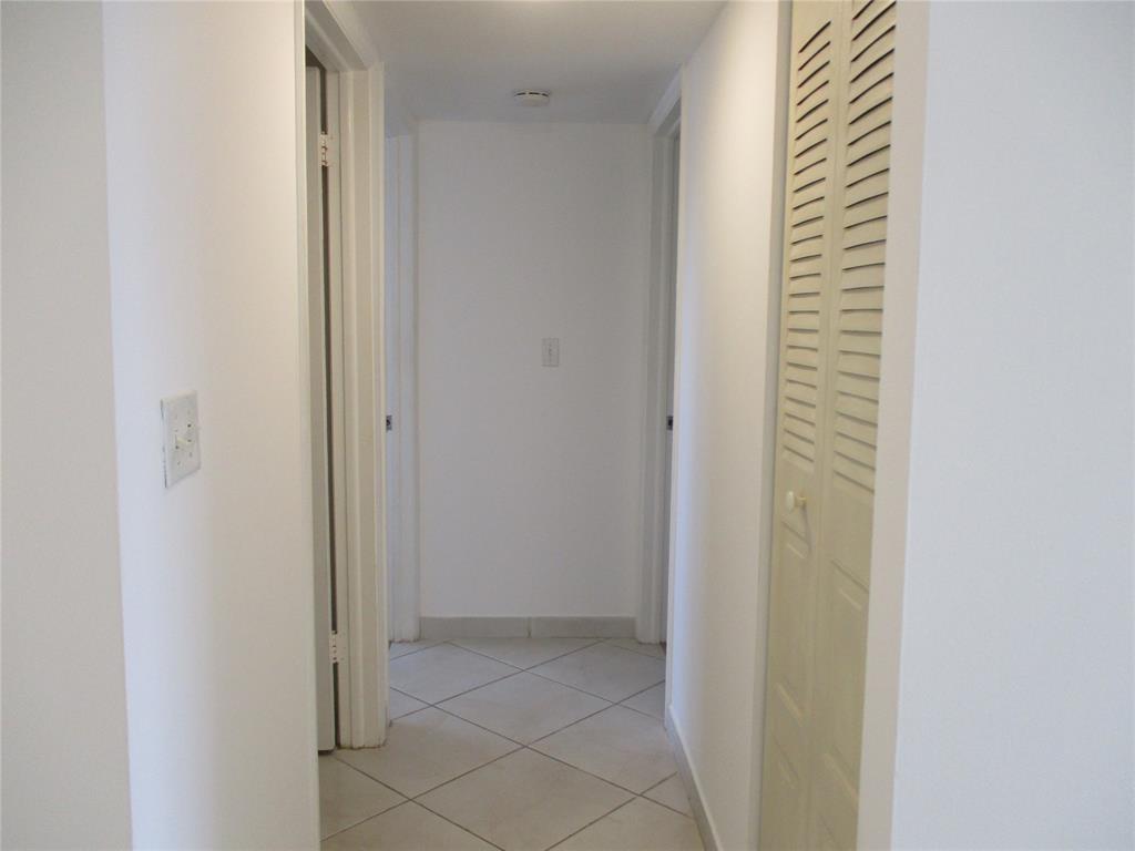 9233 Southwest 8th Street, Unit 311 Boca Raton, FL 33428 - Photo 18 of 19 a view of a hallway with closet