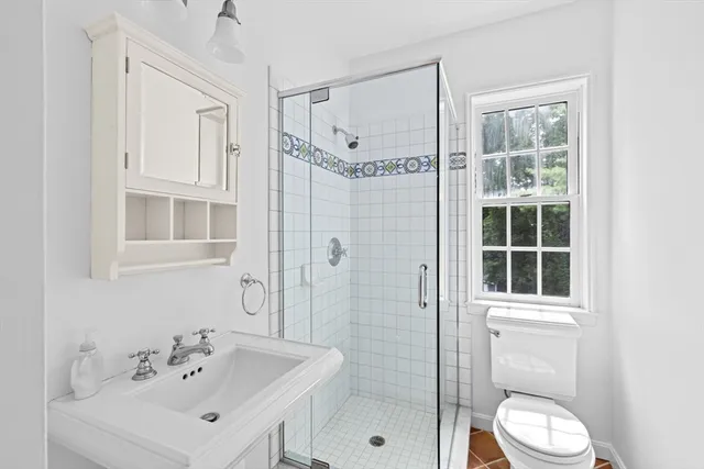 a bathroom with a sink toilet and shower