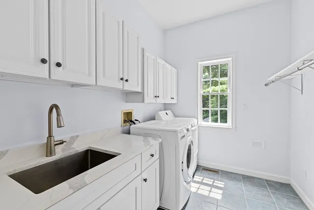 a view of a kitchen with sink washer and dryer