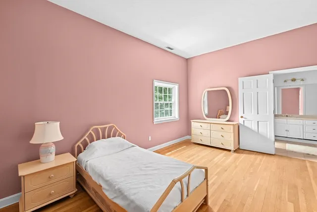 a bedroom with a bed and dresser