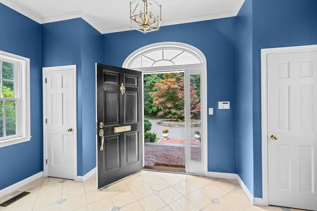 a view of an entryway with wooden floor and a chandelier