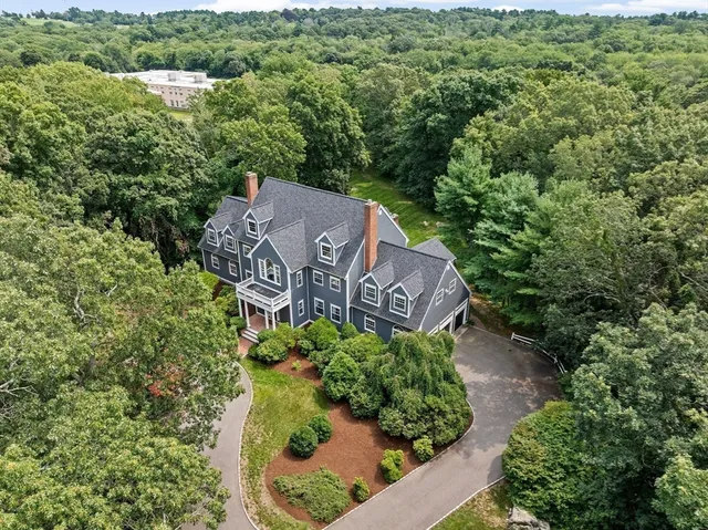 an aerial view of a house with a yard and garden