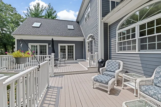 a view of a chair and tables in the balcony