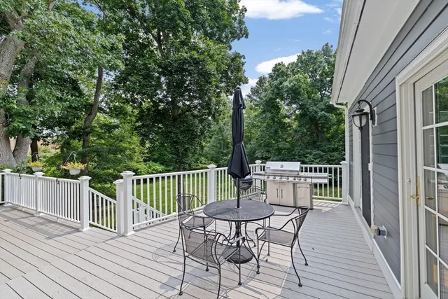 a view of a deck with furniture and wooden deck