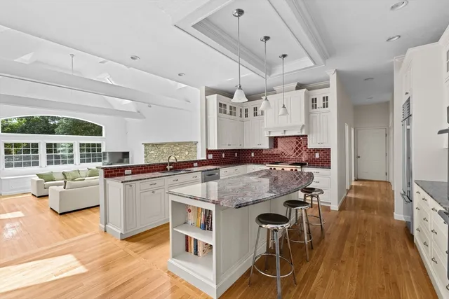 a kitchen with stainless steel appliances granite countertop a stove and cabinets