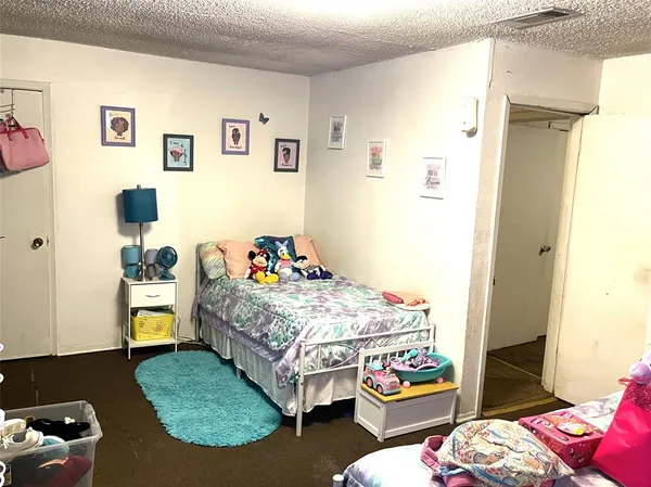 a bedroom with bed and wooden floor