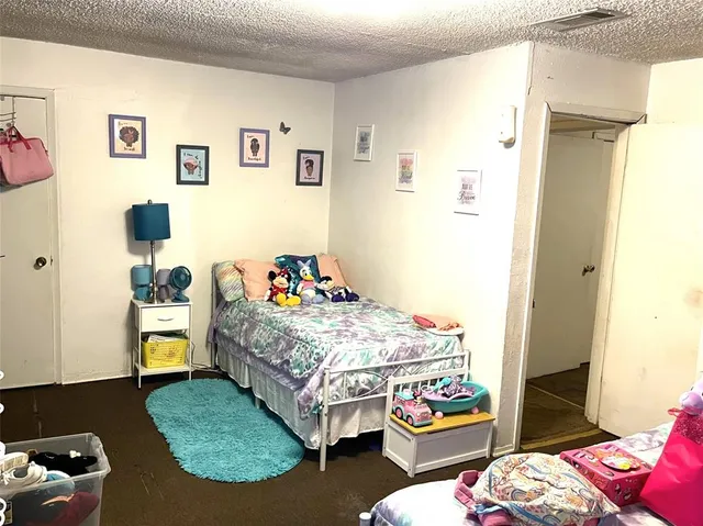 a bedroom with bed and wooden floor