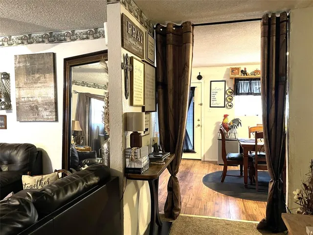 a living room with furniture and a floor to ceiling window