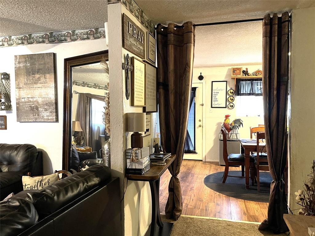 901 Washington Street Teague, TX 75860 - Photo 3 of 12 a living room with furniture and a floor to ceiling window