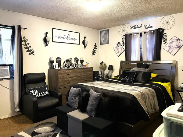 a bedroom with bed and a window