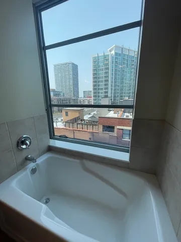 a bathroom with a bathtub and window