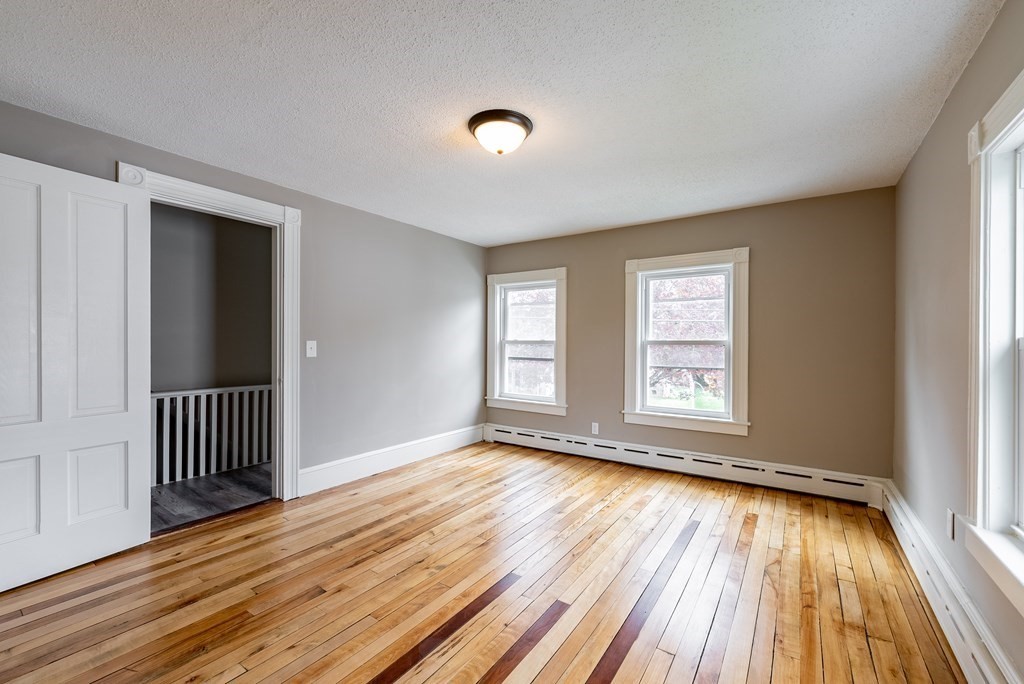 37 North Street Three Rivers, MA 01080 - Photo 11 of 35 an empty room with wooden floor and windows