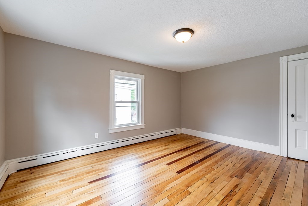 37 North Street Three Rivers, MA 01080 - Photo 12 of 35 an empty room with wooden floor and windows