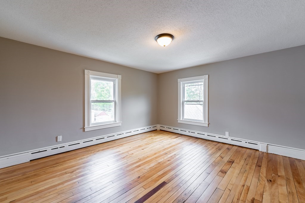 37 North Street Three Rivers, MA 01080 - Photo 14 of 35 a view of an empty room with wooden floor and a window