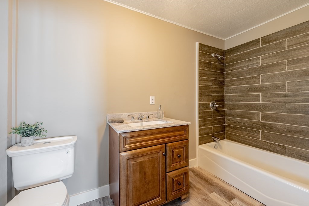 37 North Street Three Rivers, MA 01080 - Photo 17 of 35 a bathroom with a granite countertop toilet a sink and bathtub