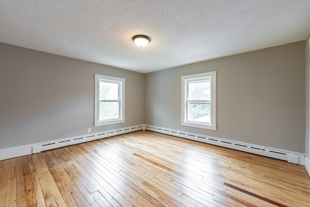 37 North Street Three Rivers, MA 01080 - Photo 19 of 35 a view of an empty room with wooden floor and a window