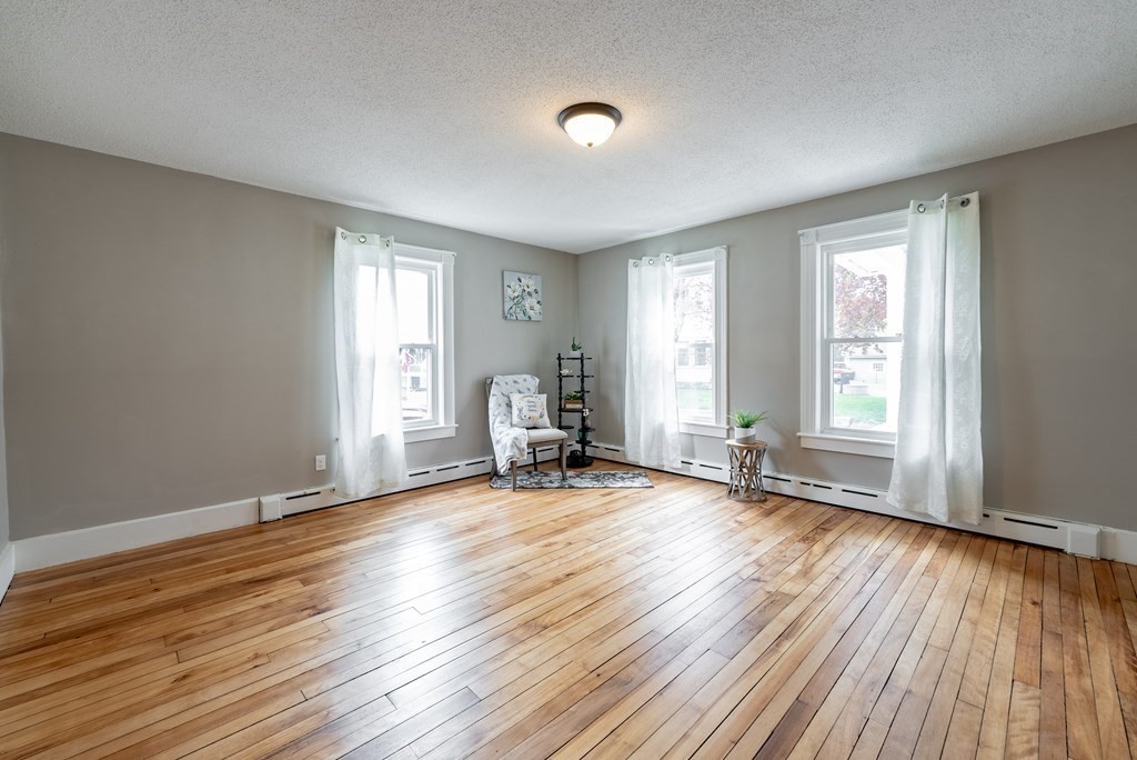 37 North Street Three Rivers, MA 01080 - Photo 7 of 35 an empty room with wooden floor and windows