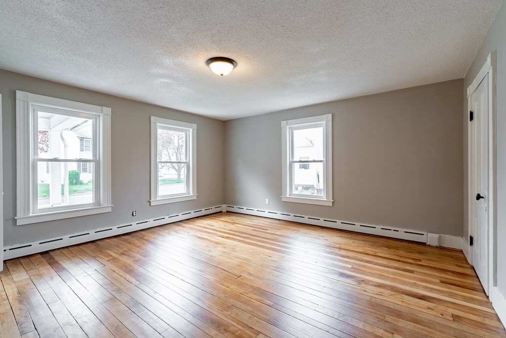 37 North Street Three Rivers, MA 01080 - Photo 10 of 35 an empty room with wooden floor and windows