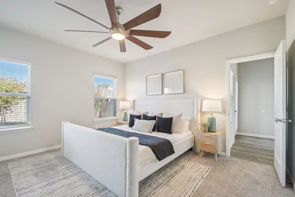 a bedroom with a large bed and a window