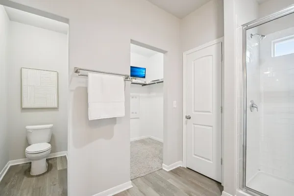a bathroom with a toilet and a shower