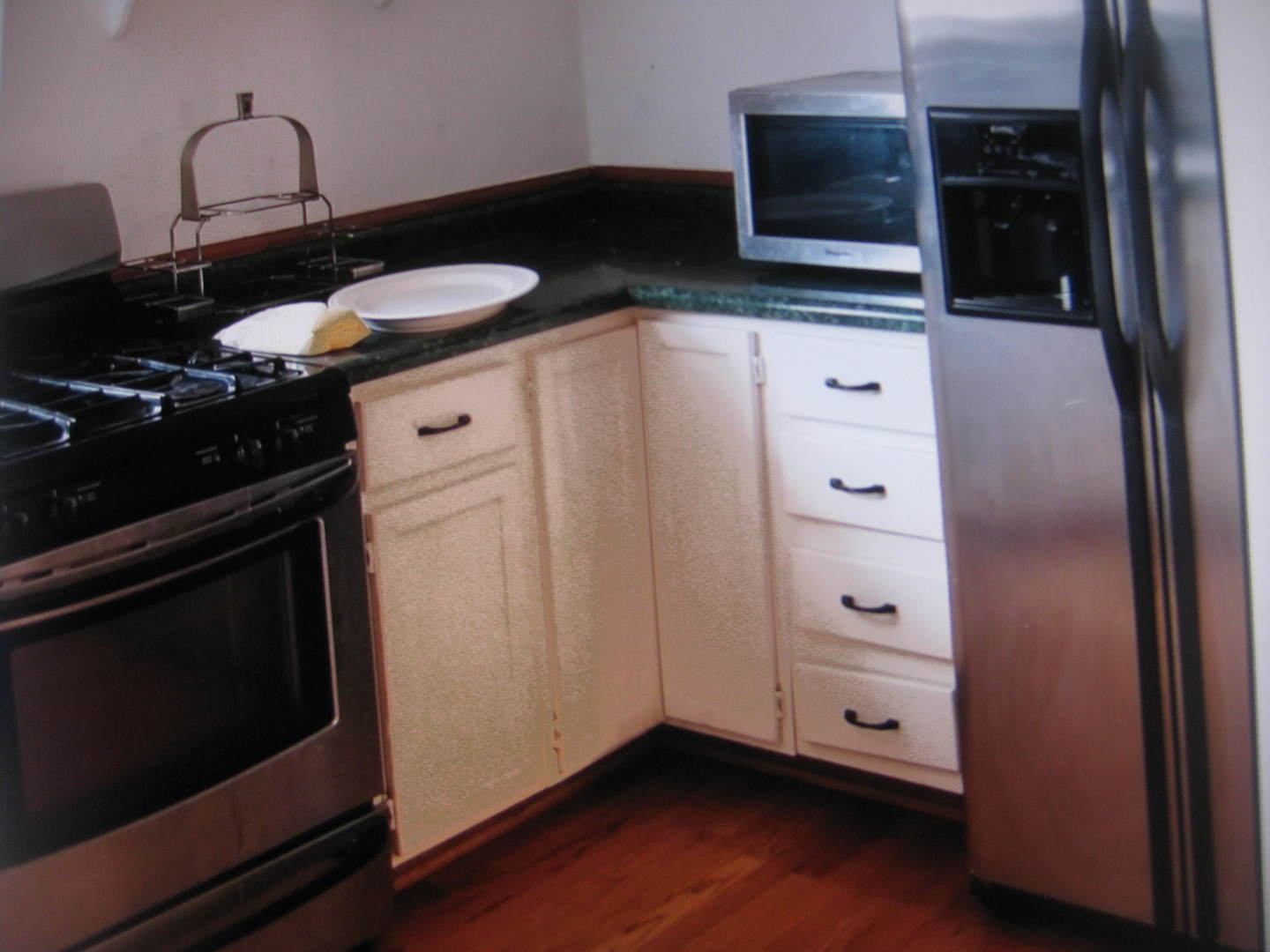 2906 North Pulaski Road Chicago, IL 60641 - Photo 7 of 9 a kitchen with stainless steel appliances a stove and a microwave