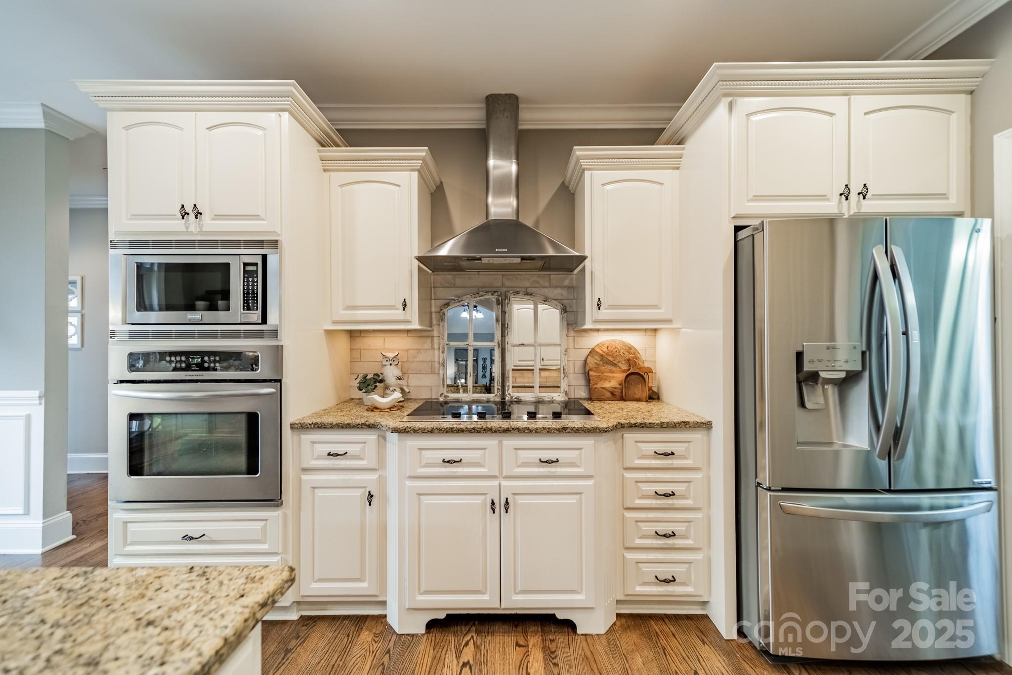 5201 Barrier Store Road Mount Pleasant, NC 28124 - Photo 11 of 46 a kitchen with stainless steel appliances a stove a refrigerator and cabinets