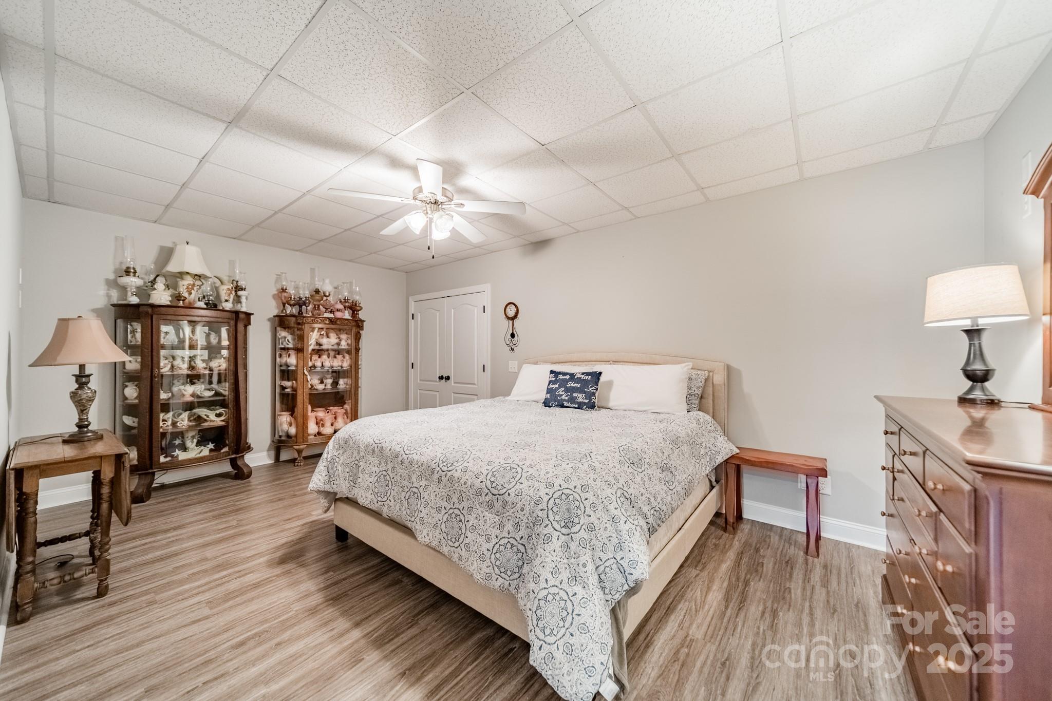 5201 Barrier Store Road Mount Pleasant, NC 28124 - Photo 32 of 46 a bedroom with a large bed lamps and a wooden floor