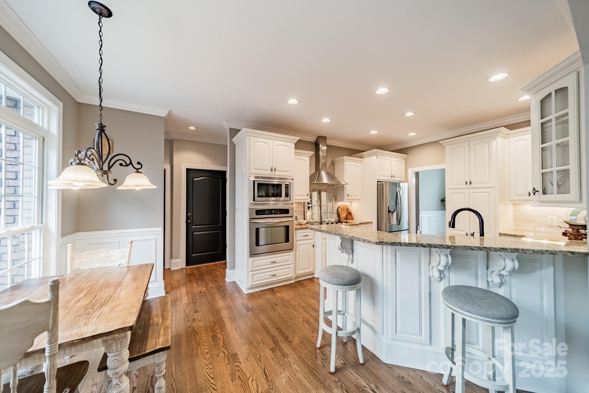 5201 Barrier Store Road Mount Pleasant, NC 28124 - Photo 10 of 46 a kitchen with stainless steel appliances kitchen island granite countertop a table chairs refrigerator and sink