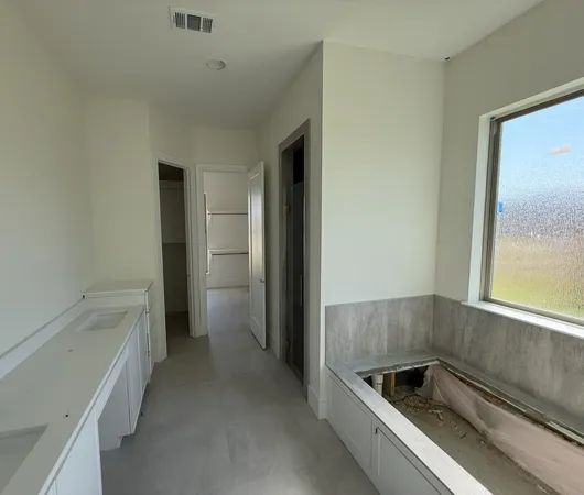 a kitchen with a refrigerator and a sink