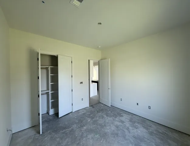 an empty room with closet area