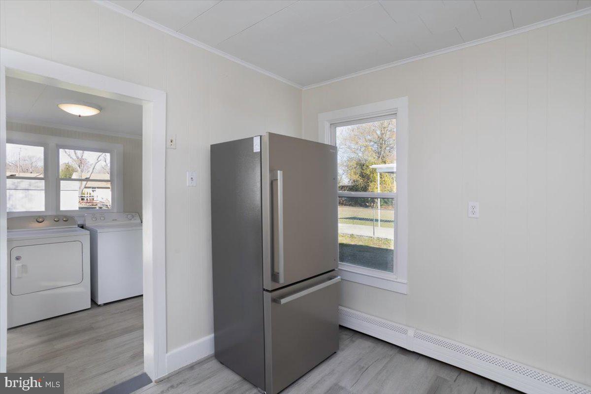 409 Oakley Street Cambridge, MD 21613 - Photo 5 of 12 a white refrigerator freezer sitting inside of a kitchen