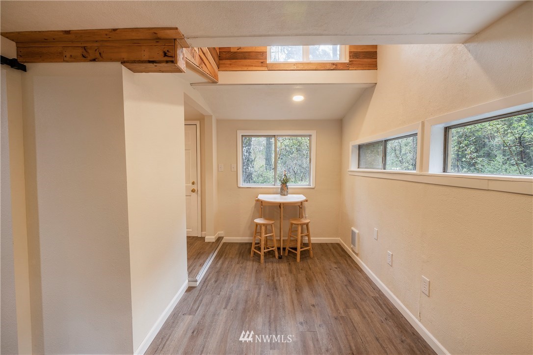 26 Webb Road Southwest Lakebay, WA 98349 - Photo 12 of 31 a view of a hallway with wooden floor and a window