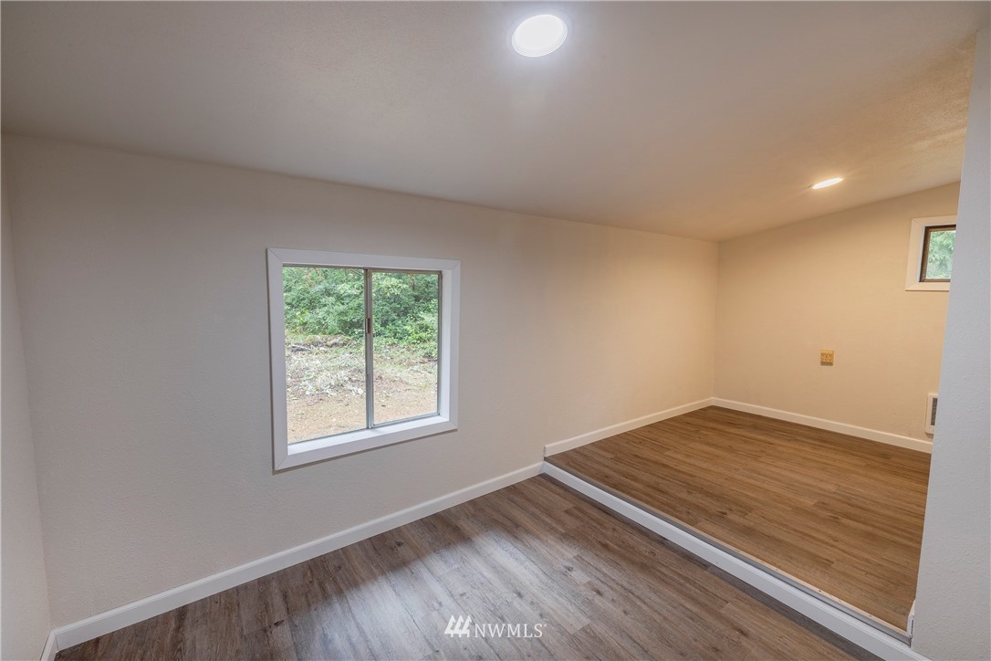 26 Webb Road Southwest Lakebay, WA 98349 - Photo 14 of 31 an empty room with wooden floor and windows