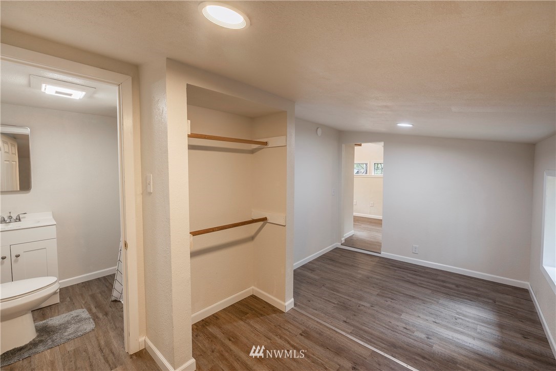 26 Webb Road Southwest Lakebay, WA 98349 - Photo 16 of 31 a view of hallway with wooden floor and bathroom