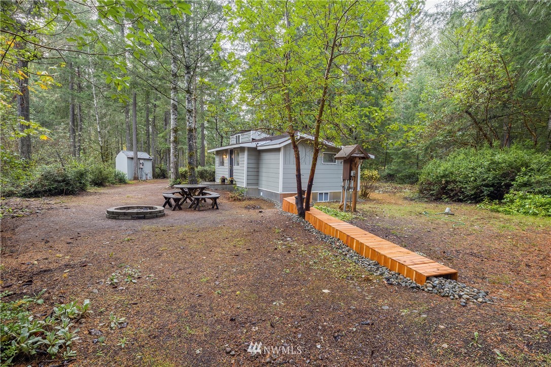 26 Webb Road Southwest Lakebay, WA 98349 - Photo 18 of 31 a view of a house with backyard and trees