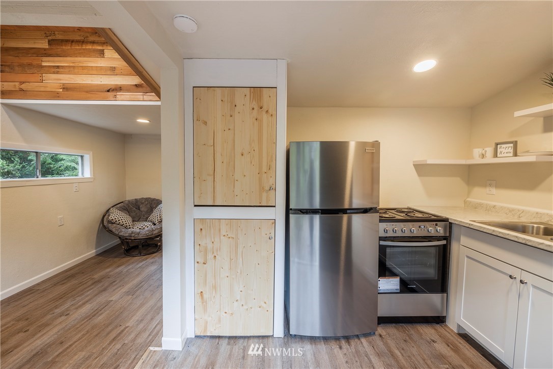 26 Webb Road Southwest Lakebay, WA 98349 - Photo 8 of 31 a kitchen with a refrigerator and a sink