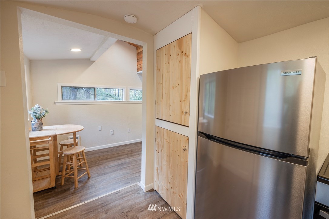 26 Webb Road Southwest Lakebay, WA 98349 - Photo 9 of 31 a view of a refrigerator in kitchen and wooden floor