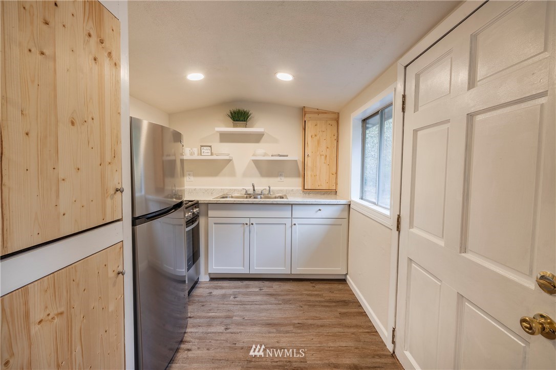 26 Webb Road Southwest Lakebay, WA 98349 - Photo 10 of 31 a kitchen with kitchen island granite countertop appliances cabinets and a sink