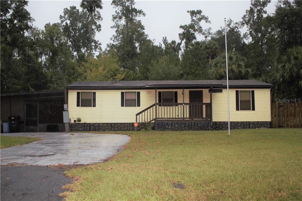 24322 Fox Road Astor, FL 32102 - Photo 1 of 1 a view of a house with a backyard