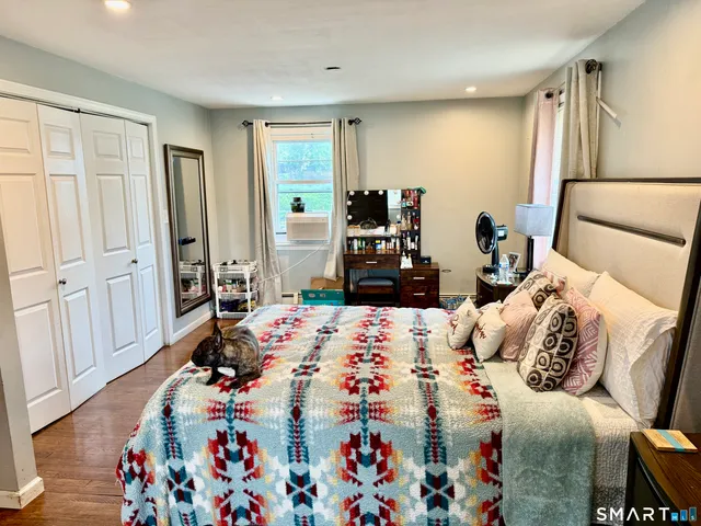 a bedroom with a bed and a mirror