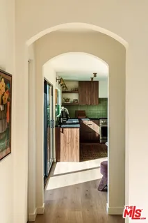 a kitchen with stainless steel appliances a refrigerator sink and wooden cabinets