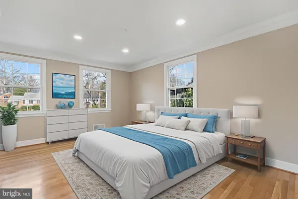 a bedroom with a large bed and a large window