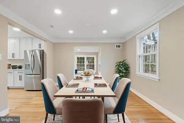 a dining room with furniture a window and stainless steel appliances