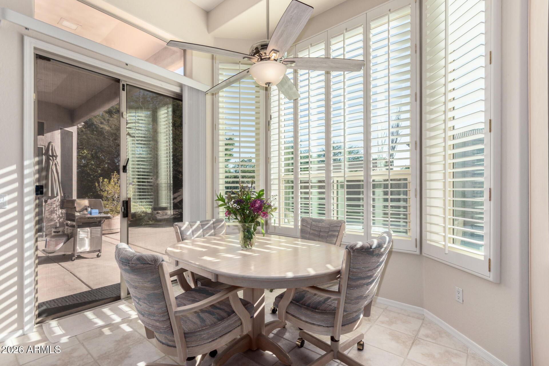 4419 East Robin Lane Phoenix, AZ 85050 - Photo 11 of 28 a dining room with furniture and large windows