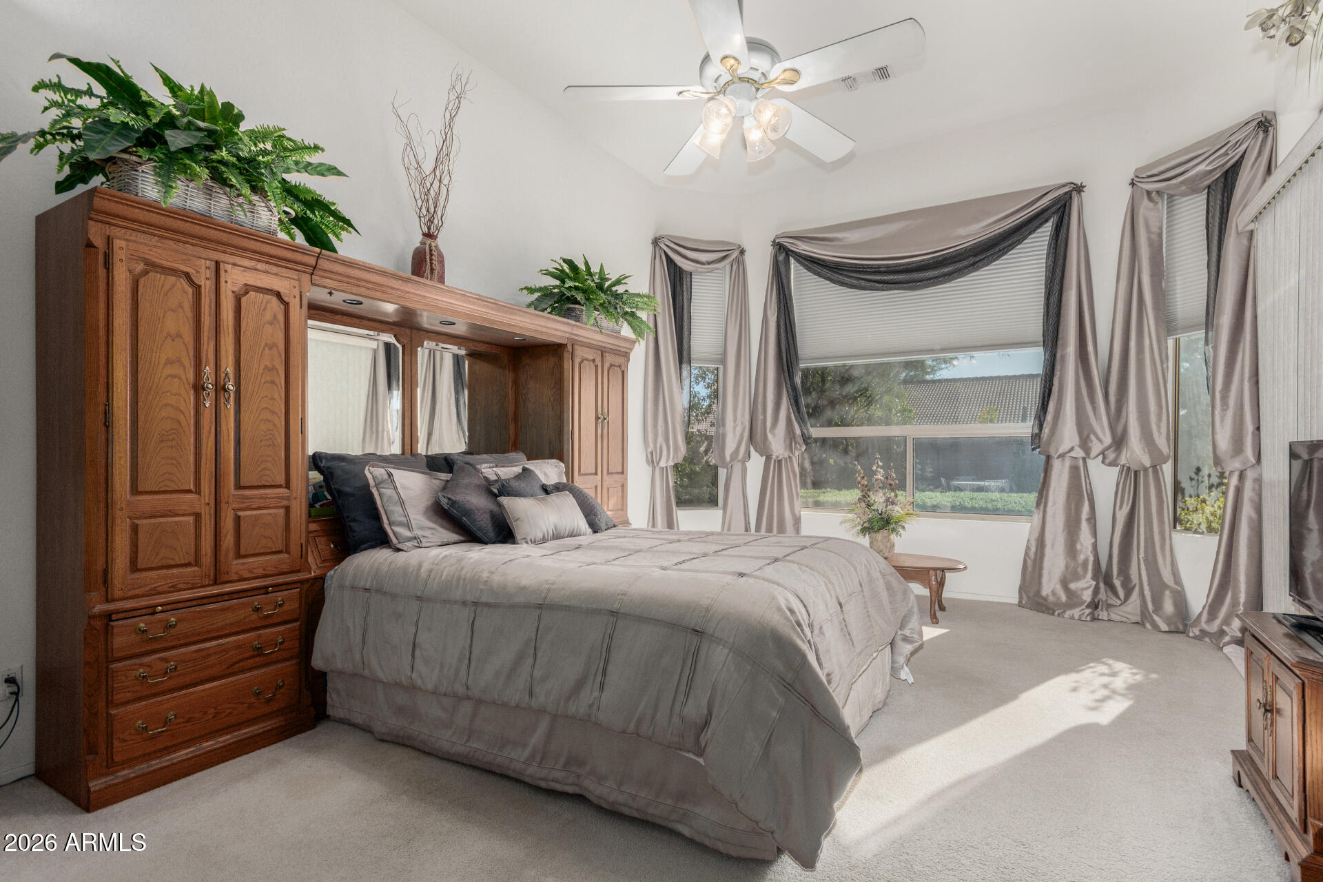 4419 East Robin Lane Phoenix, AZ 85050 - Photo 12 of 28 a bedroom with a large bed and a chandelier