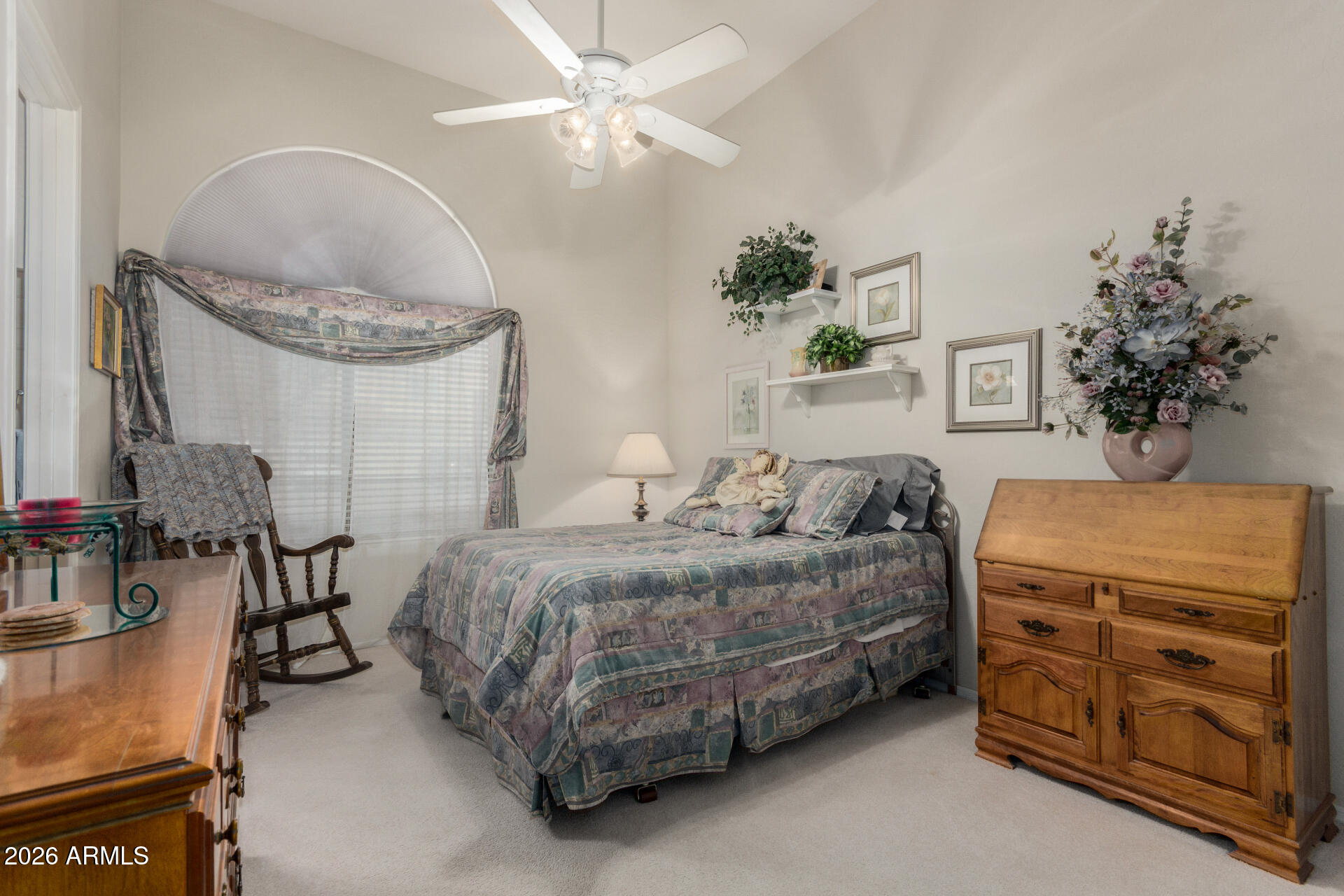 4419 East Robin Lane Phoenix, AZ 85050 - Photo 16 of 28 a bedroom with a bed and a chandelier