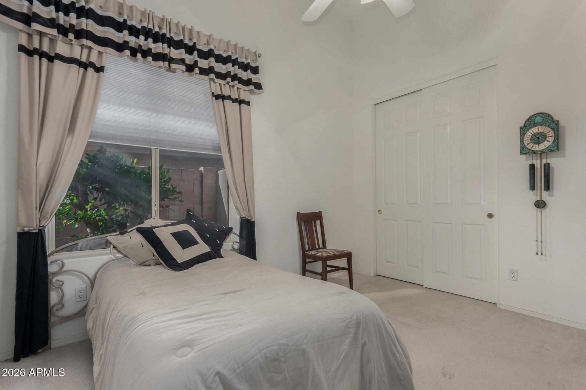 4419 East Robin Lane Phoenix, AZ 85050 - Photo 19 of 28 a bedroom with a bed and a window