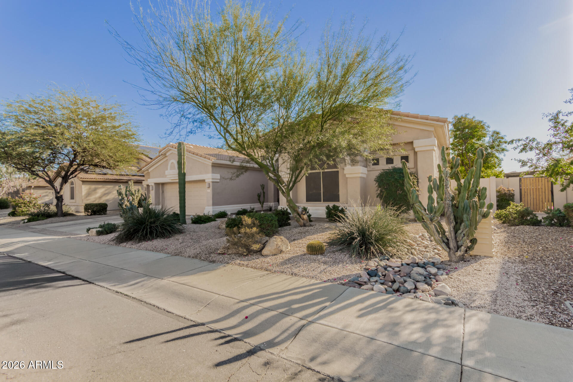 4419 East Robin Lane Phoenix, AZ 85050 - Photo 2 of 28 a view of a house with a tree in front of it
