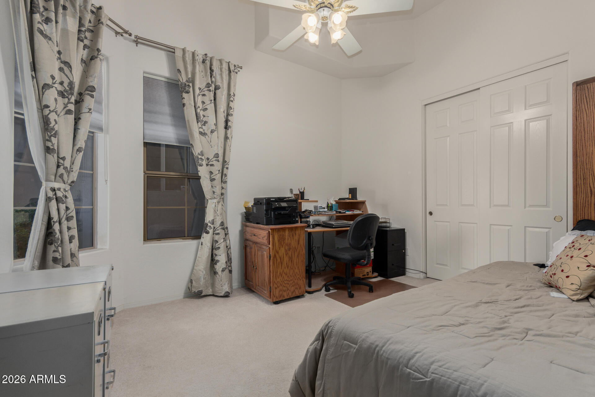 4419 East Robin Lane Phoenix, AZ 85050 - Photo 21 of 28 a bedroom with a bed and a chandelier